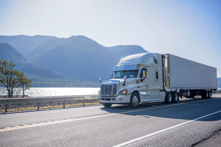 A truck driving past a lake in El Paso, cross-border freight shipping