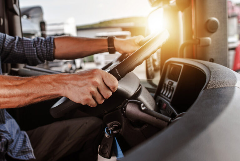 A person’s hands on the steering wheel of a truck in El Paso.
